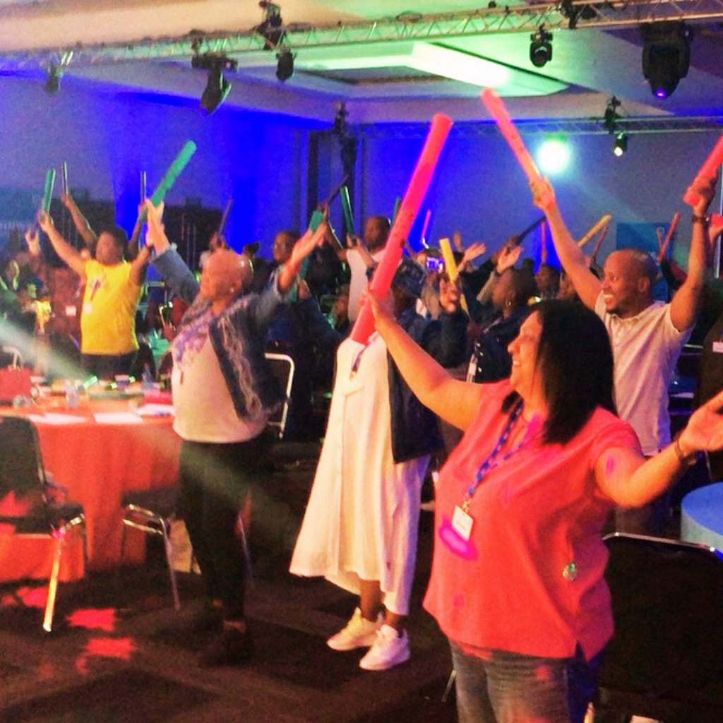 3. Coworkers tapping rhythms with Boomwhackers