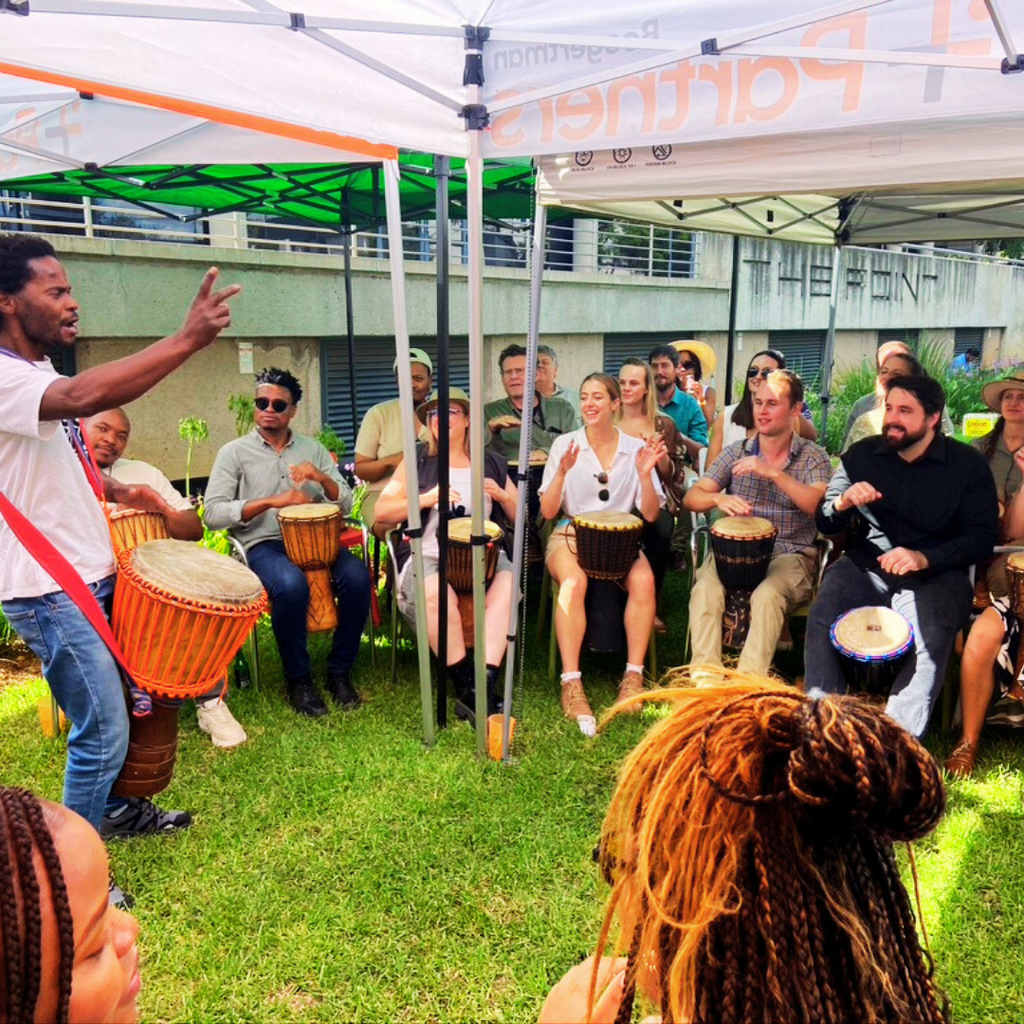 Corporate group enjoying drumming session