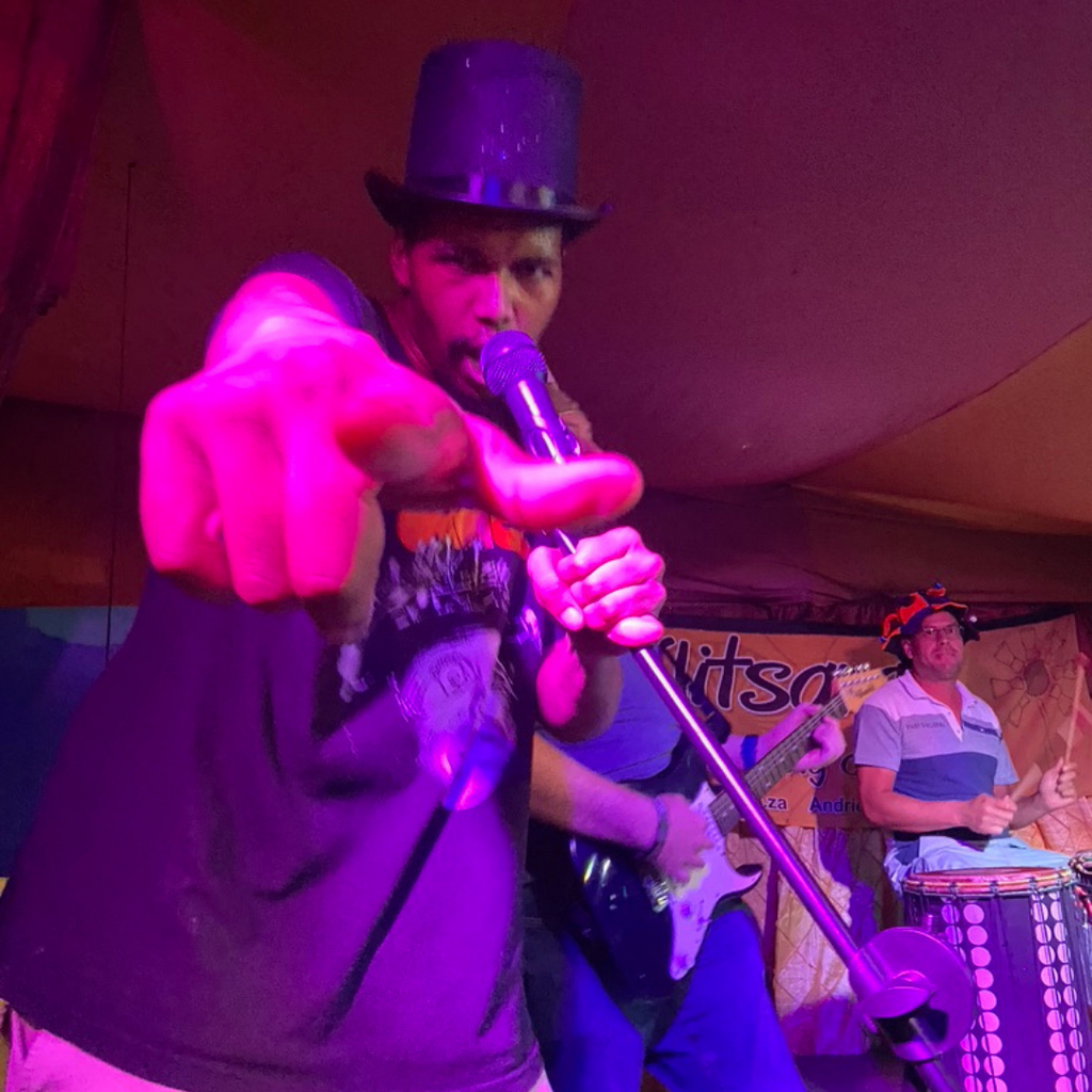 Employee lip syncing on stage with a mic